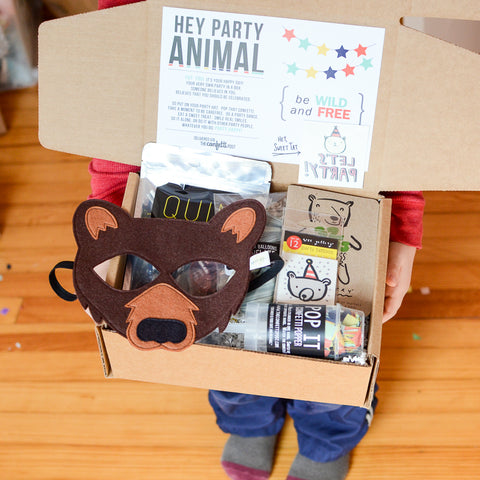 Bash the Bear kid's gift package to send for a long distance birthday.  Filled with bear felt mask, strawberry lollipop candy, party animal tattoos, bear coloring book, confetti popper, and two balloons.