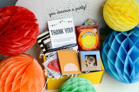 Thank you gift box surrounded by tissue pom balls: 12 Best Remote Employee Gift Ideas