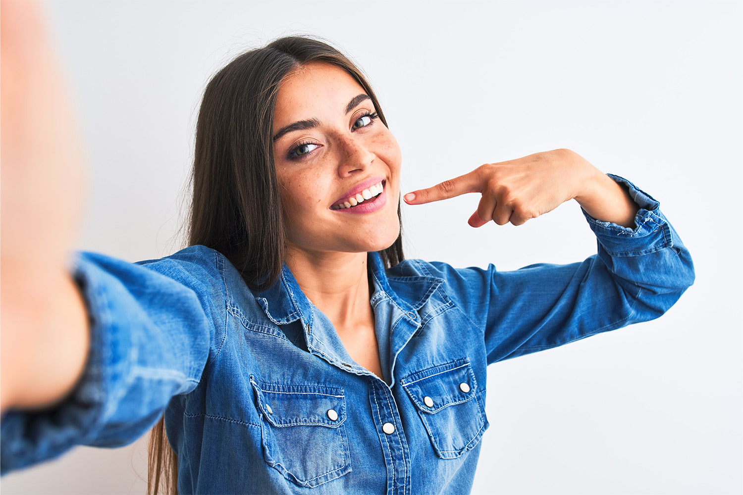 happy woman pointing to her smile