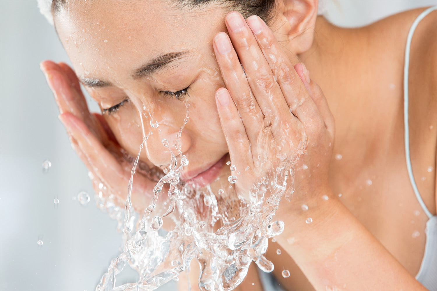 woman washing her face