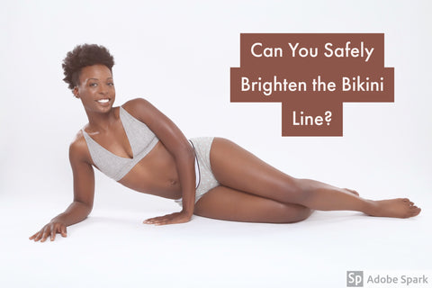 African American woman posing laying down in gray top and boxer briefs