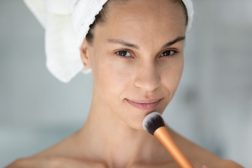 woman applying makeup 