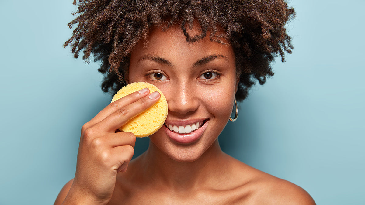 African American woman with facial sponge 