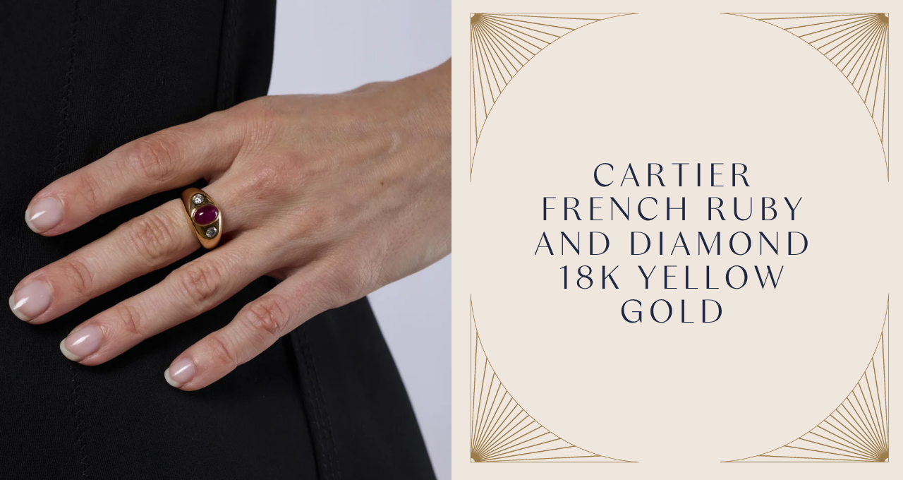 A close-up of a hand wearing a bold Cartier French ring in 18K yellow gold, showcasing an oval cabochon ruby framed by two bezel-set diamonds. The sculptural gold band exudes vintage glamour and timeless elegance.