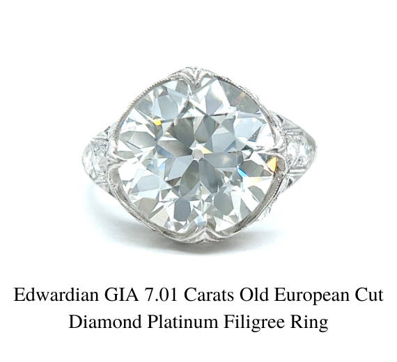 Close up of a 7.01 Carats Old European Cut Edwardian GIA Diamond Platinum Filigree Ring on white background.
