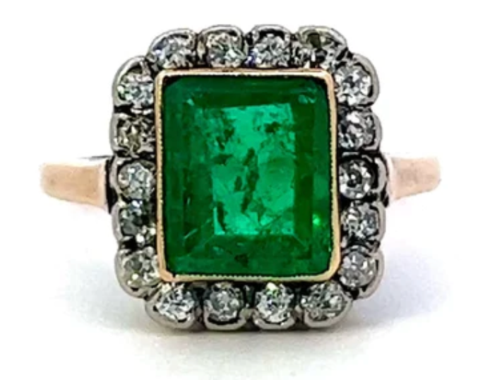 Victorian emerald diamond cluster ring on a yellow gold setting