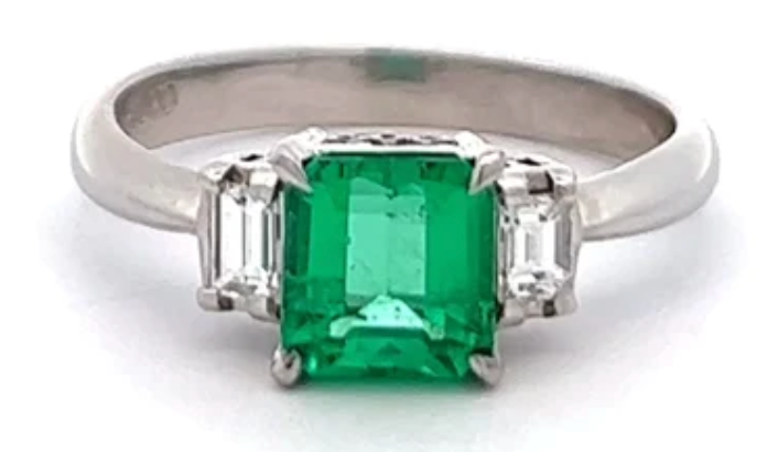 vintage emerald diamond three stone ring on a platinum setting            
