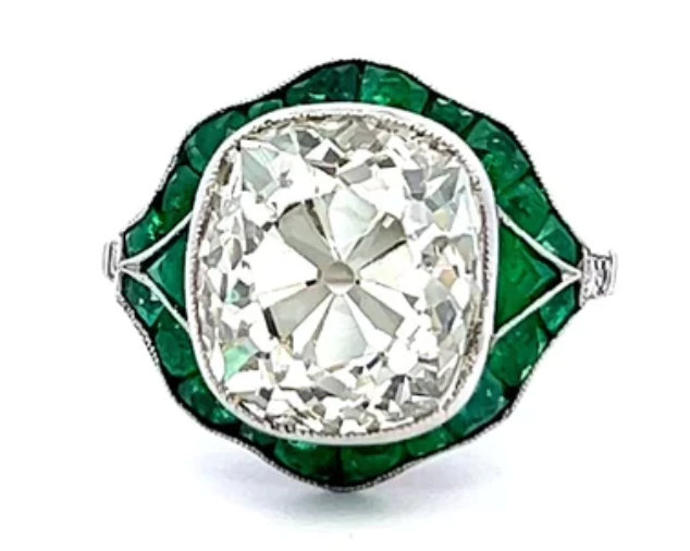 6.62 carat old mine cut diamond ring surrounded by emeralds on a platinum setting