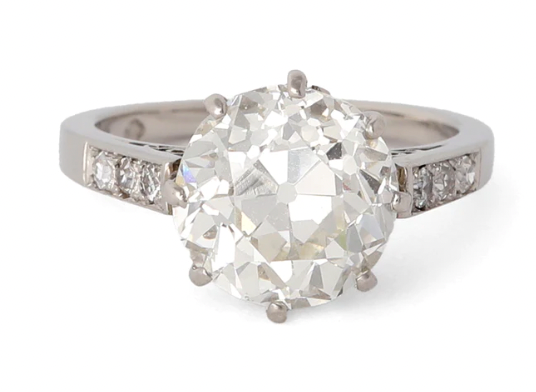 4.28 carat old european cut diamond accented by six single cut diamonds on a platinum setting