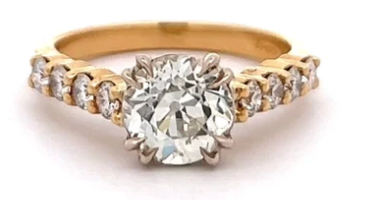 1.67 carats old european cut diamond  accented by eight round round brilliant cuton a 18k yellow gold ring