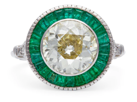 Art deco inspired 2.51 carat old european cut diamond surrounded by emeralds on a white gold target ring