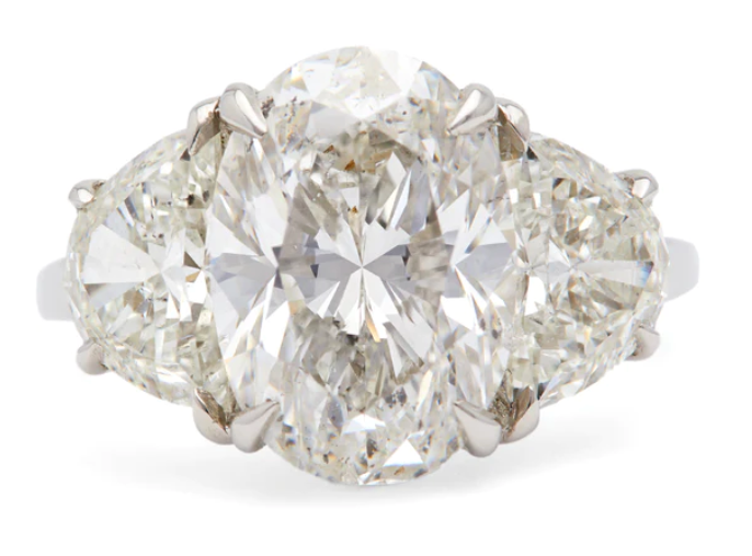 GIA 5.01 carat oval cut three stone diamond ring on a platinum setting
