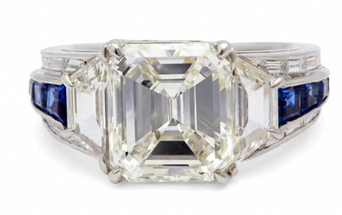 4.54 Carat emerald cut diamond ring accented by two trapezoid and eight round brilliant cut diamonds