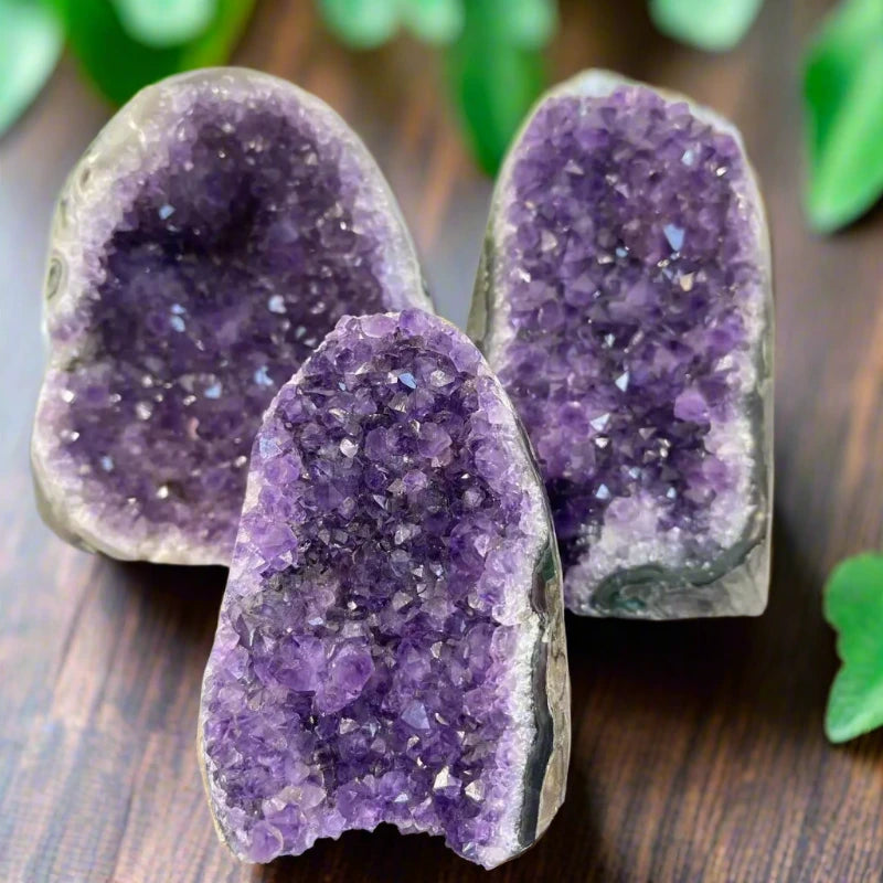 Raw natural amethyst crystal cluster with rich purple points, placed on a white background – ideal for healing, energy work, or home decor.