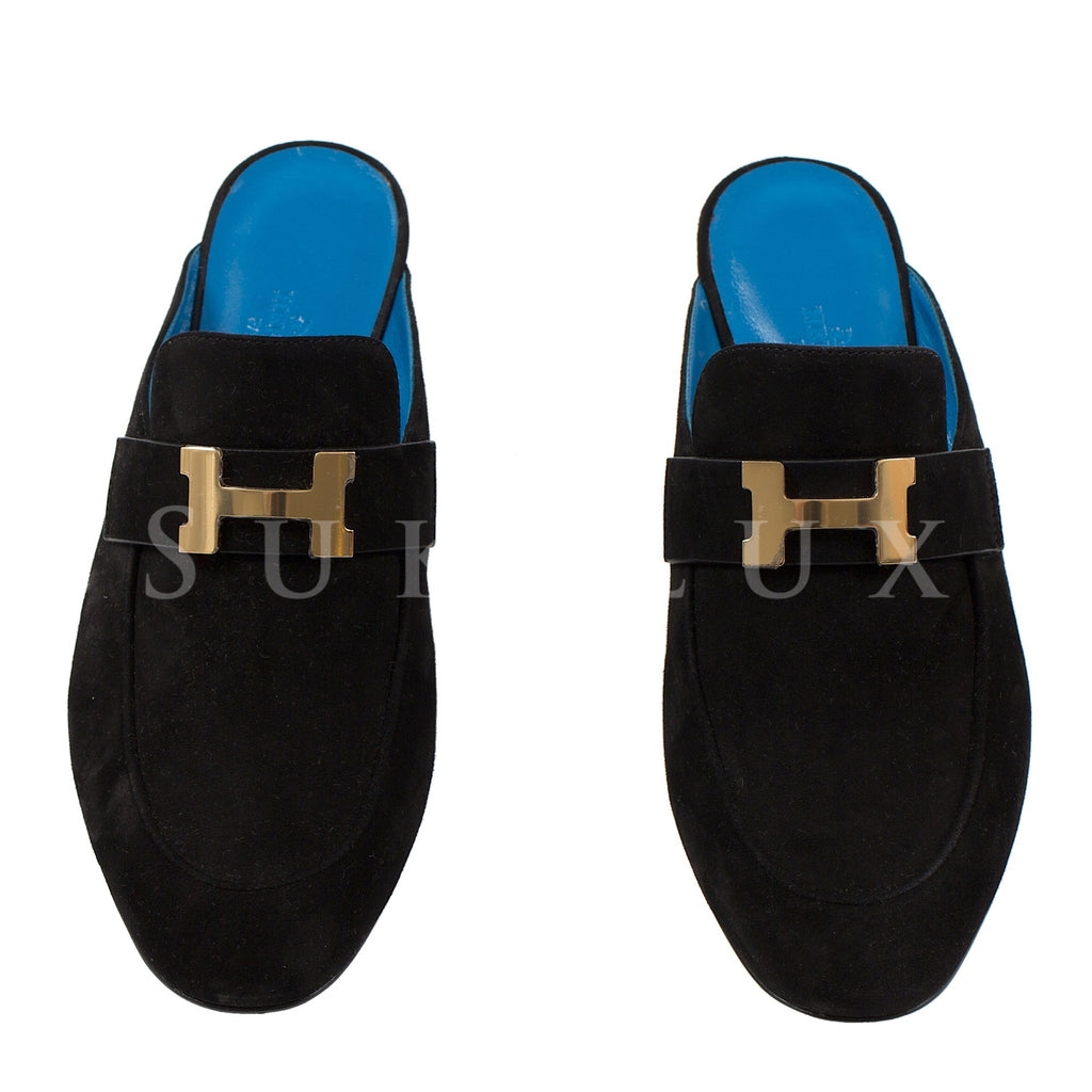 black loafers with gold buckle