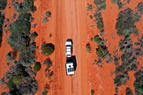 Car pulling a caravan in the Australian desert