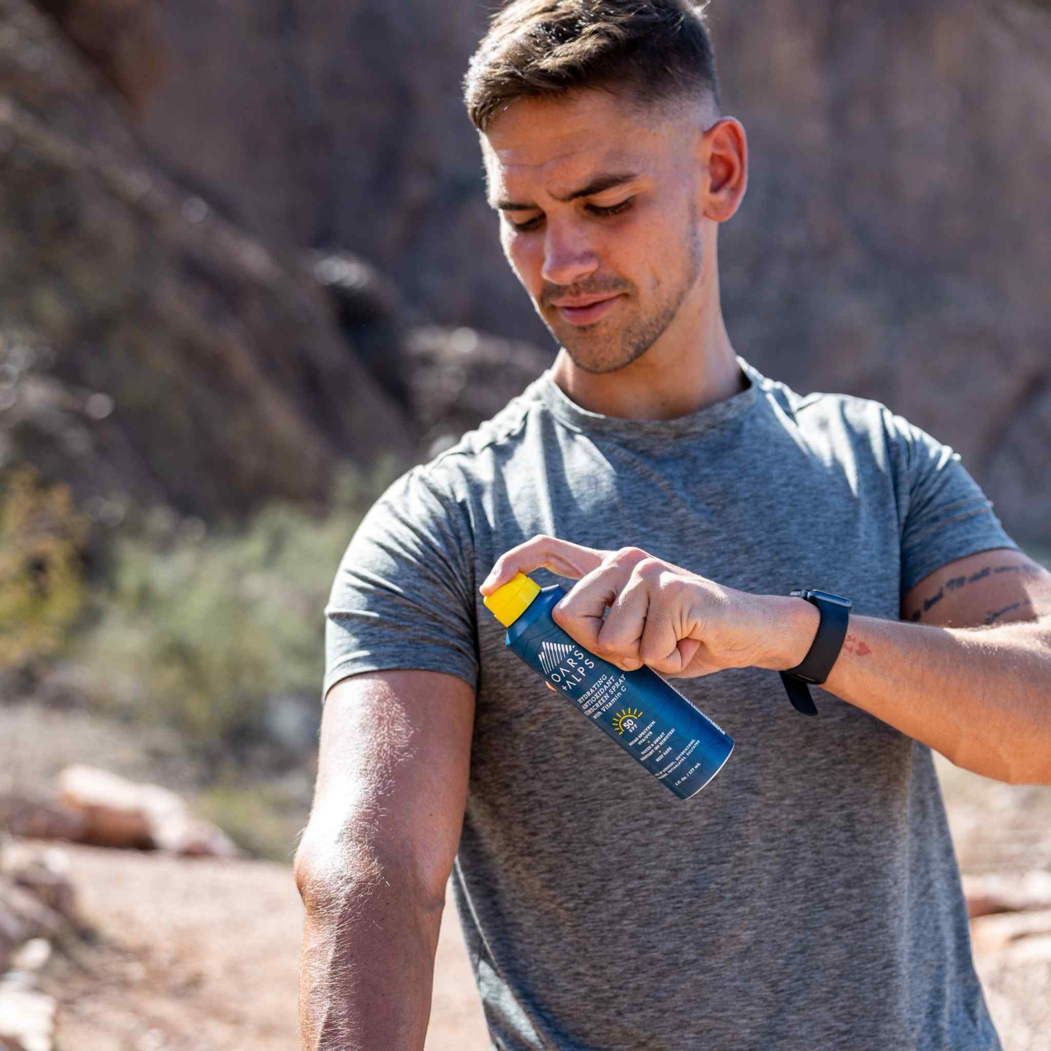 Man applying sunscreen to arm