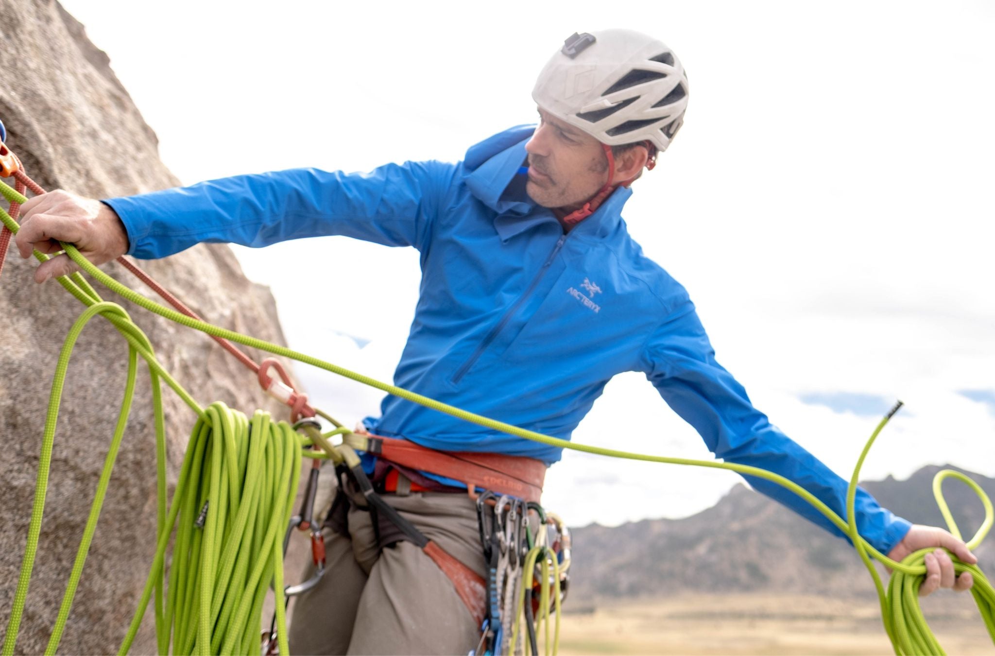 Matt Walker hoisting rope while climbing