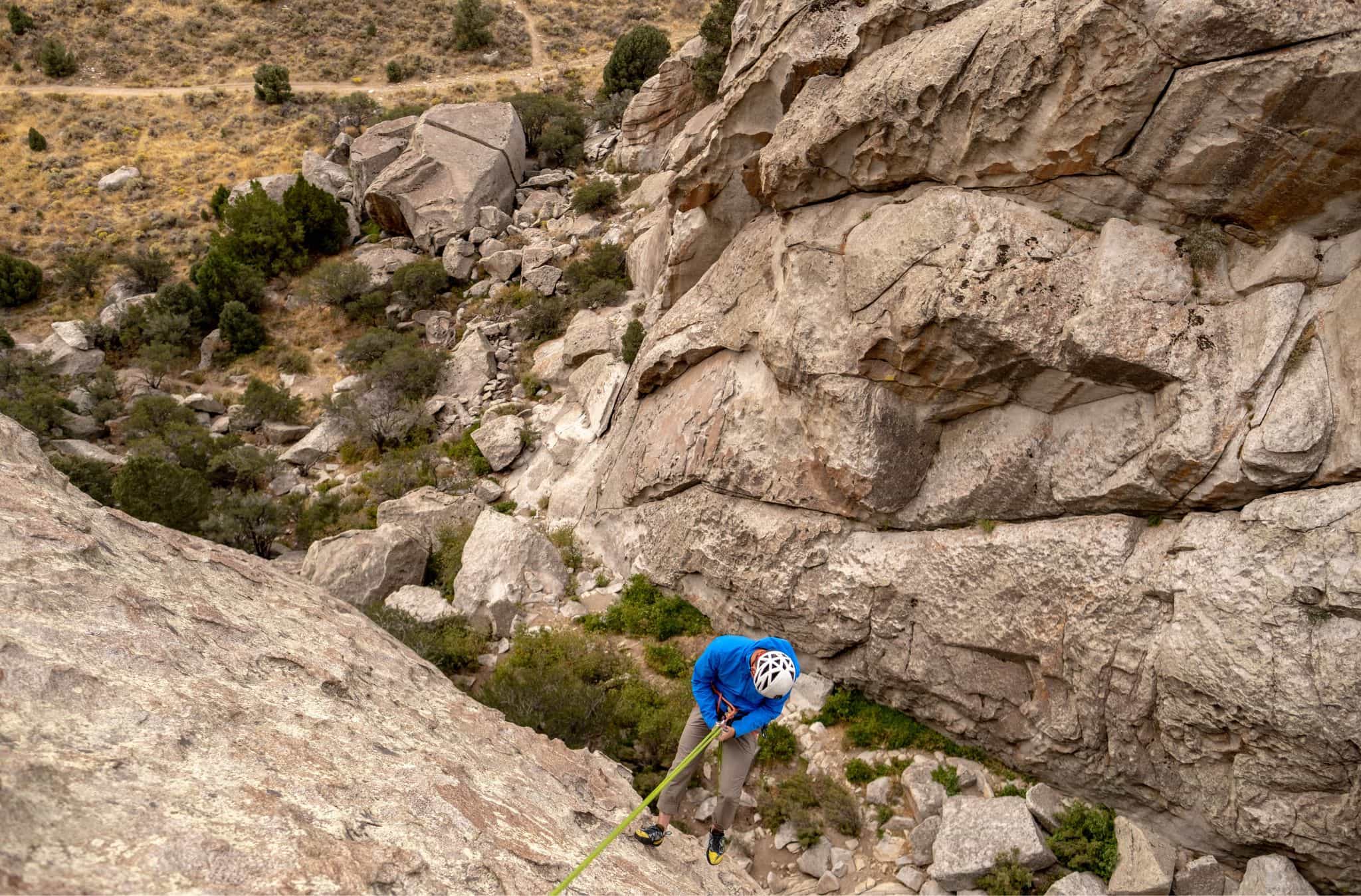 Matt Walker repelling down a rock face