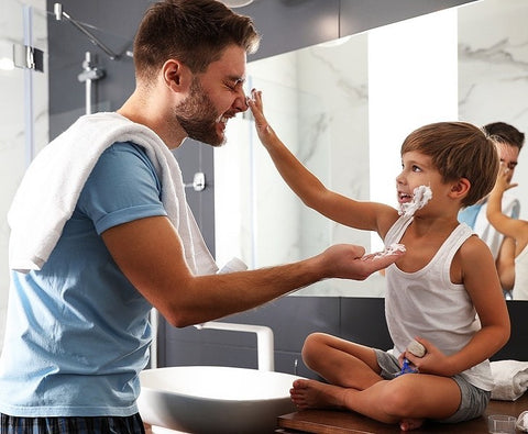 A father teaching his son how to shave.