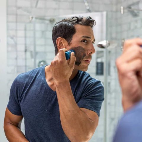 A man exfoliating his face with the Solid Charcoal Face Wash