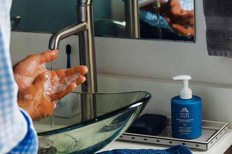 Man washing hands with Oars + Alps' Hydrating Hand Wash at sink