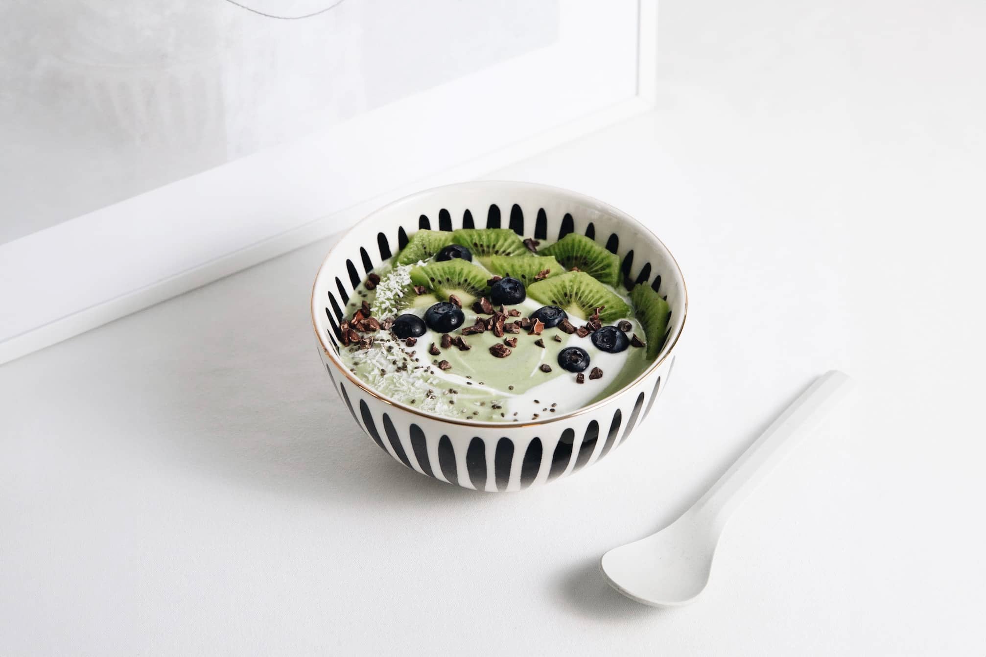 Organic Matcha yoghurt breakfast bowl with fruit 