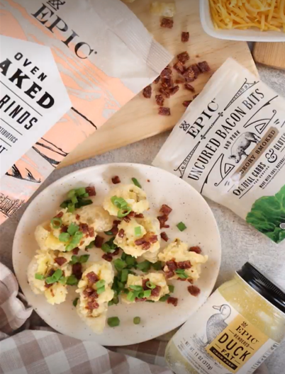 A bowl of EPIC Pork Rinds loaded with whipped potatoes, cheese, and EPIC Hickory Topper Bits.