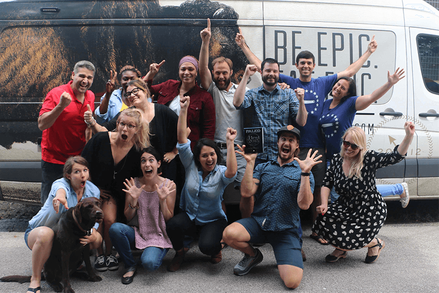 EPIC team in funny poses in front of van 