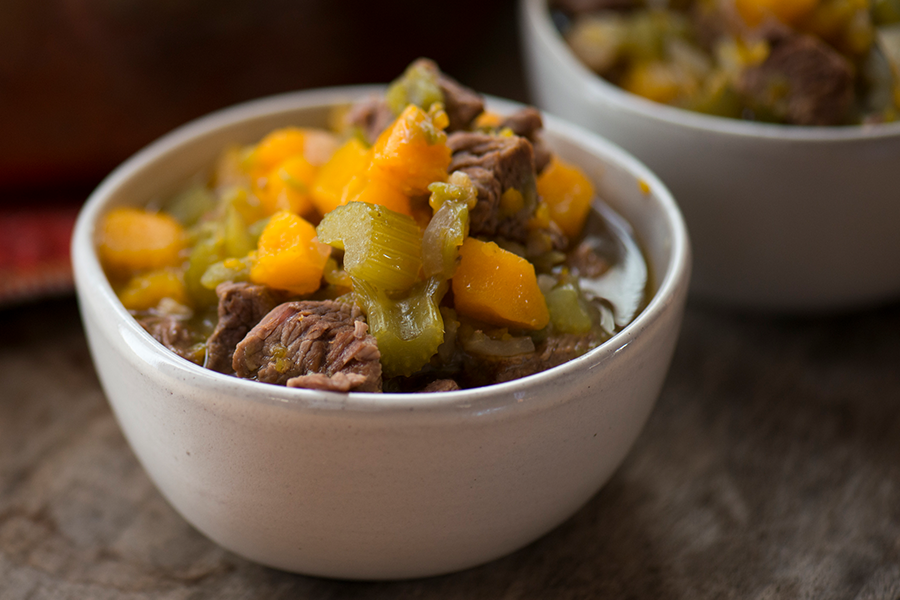 Bowl of beef stew with butternut squash and celery 