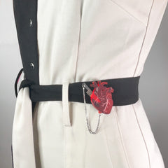 Vinca's Heart of Aghast Brooch pinned to waistband of suit.