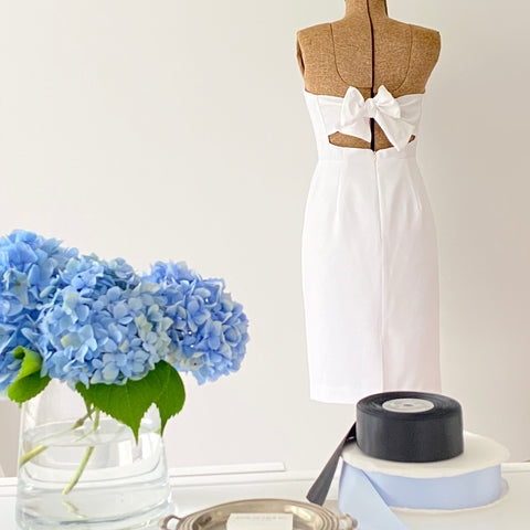 Short White Wedding Dress for Bride to wear as a Bridal Shower Dress Blue Hydrangeas in vase Blue Ribbon and Black Ribbon 