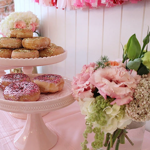 Pink the Town Glitter Donuts Pink Milk Glass Cake Stand Hydrangea, Lisianthus and Roses in crystal vase