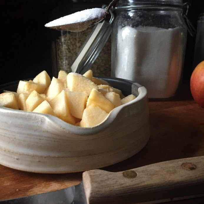 Apple Crisp Apples in Brie Baker sprinkling sugar