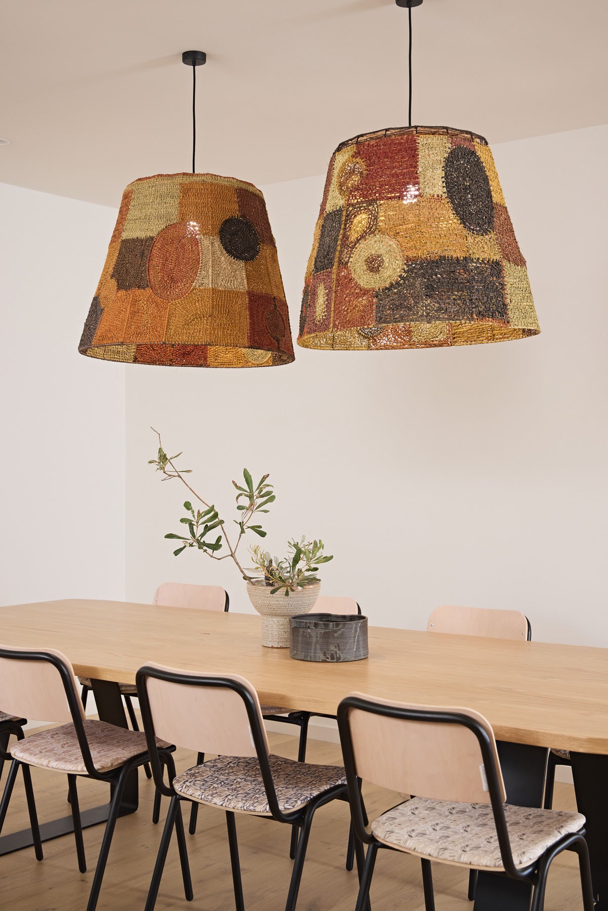 Two large Yuta Badayala pendants above the Stirrup Dining Table