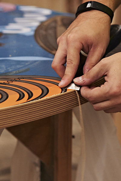 Finishing the edge of the plywood top.