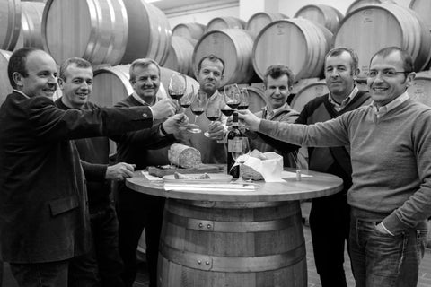 Ilatium Morini Brothers and Cousin Owners sharing wine in the barrel cellar