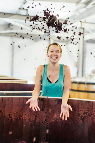 Nadia Barnard, winemaker at Waterkloof, throwing crushed grape skins into the air at the winery.