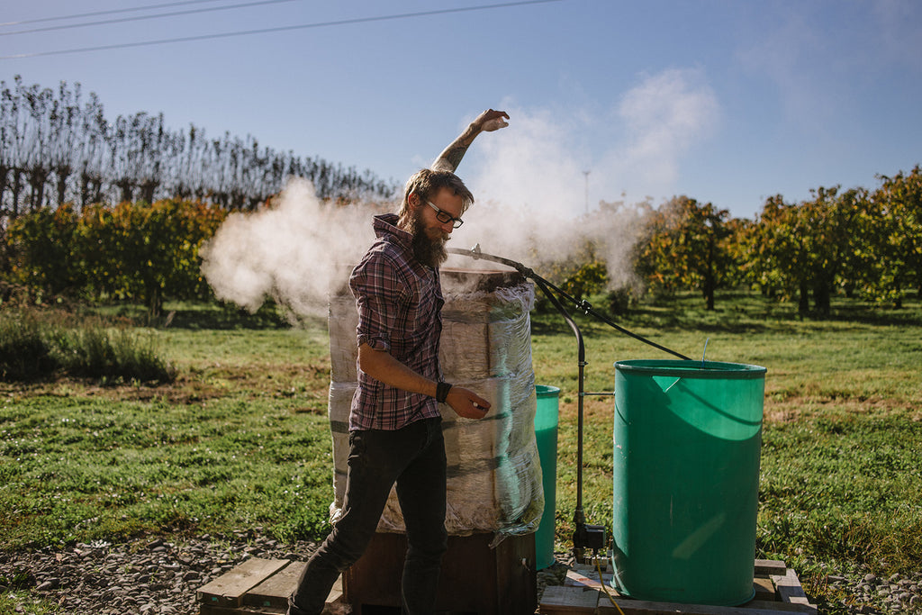 Wills working the steam box (The Paper Rain Project Recycled Wine-barrel Art Longboards)