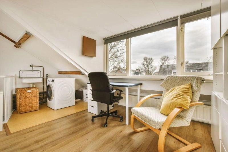 A modern desk chair with a minimalist design in a compact home office, demonstrating the versatility and style of modern desk chairs.