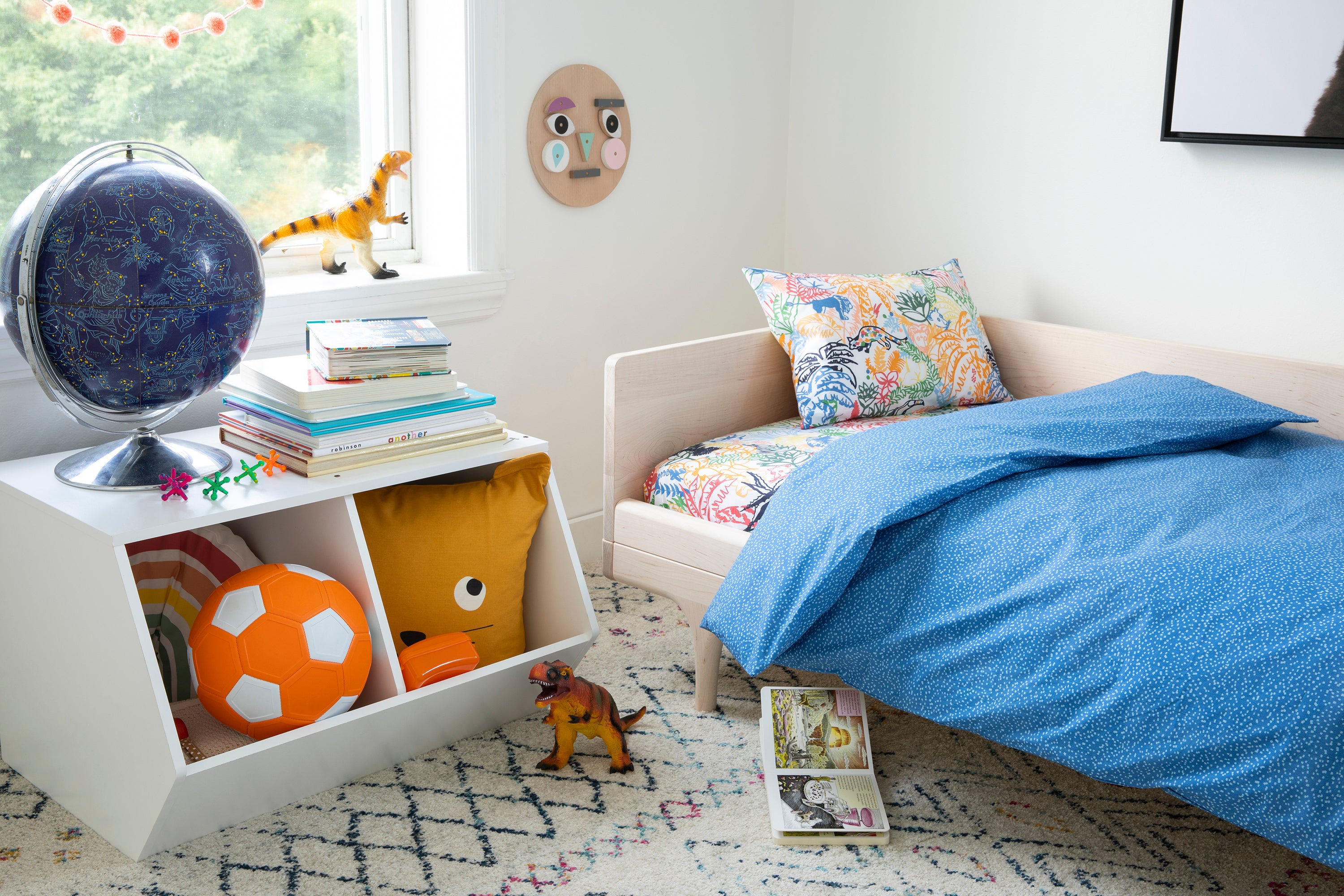 Brooklinen's Toddler Sheet Set in "Jungle in Multi" paired with the Duvet Cover in "Dotty in Blue."