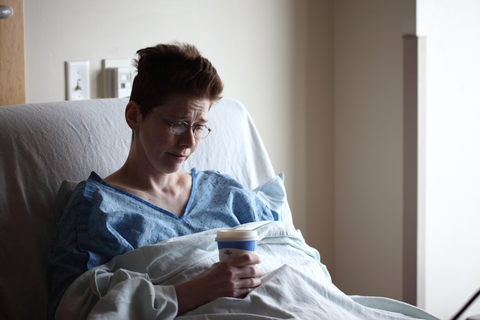 a patient holding a Styrofoam cup