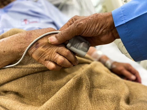 a person holding an elderly person's hands