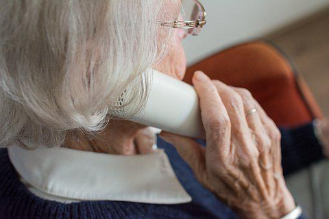 a woman holding a phone receiver up to her ear