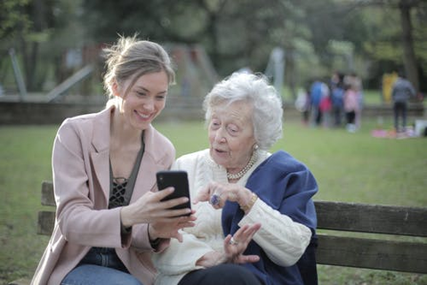 an elderly woman looking at a smartphone