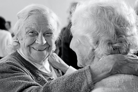 two old women holding each other