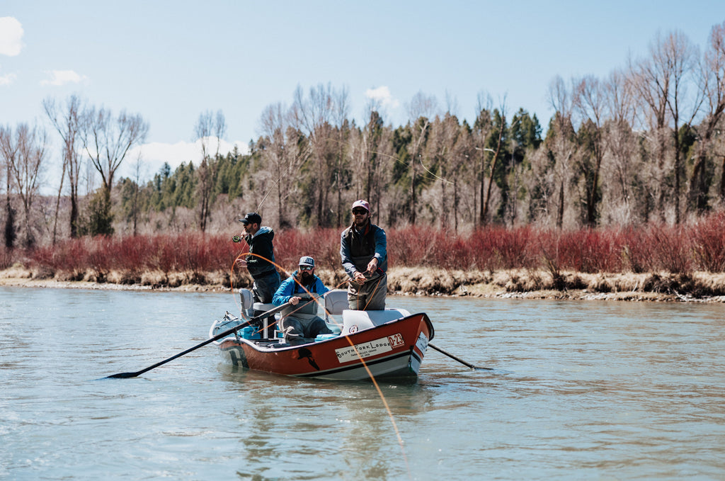 In this image, from Moonshine Rods, an angler is casting a fly rod from a drift boat.