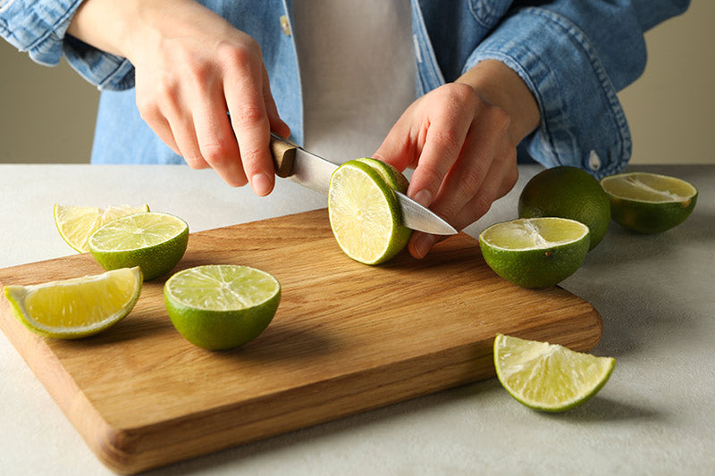 Slicing Lime For An Easy Margarita Recipe With 3 easy ingredients