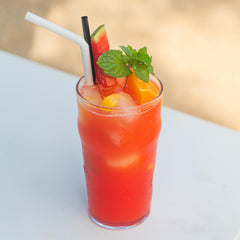 Sunny Paradise Punch Drink Recipe made from dark rum, mango & guava syrups and garnished with fruit