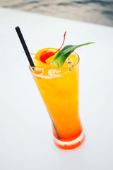 Tropical Sunset Drink Recipe made from dark rum & passion fruit & garnished with fruit